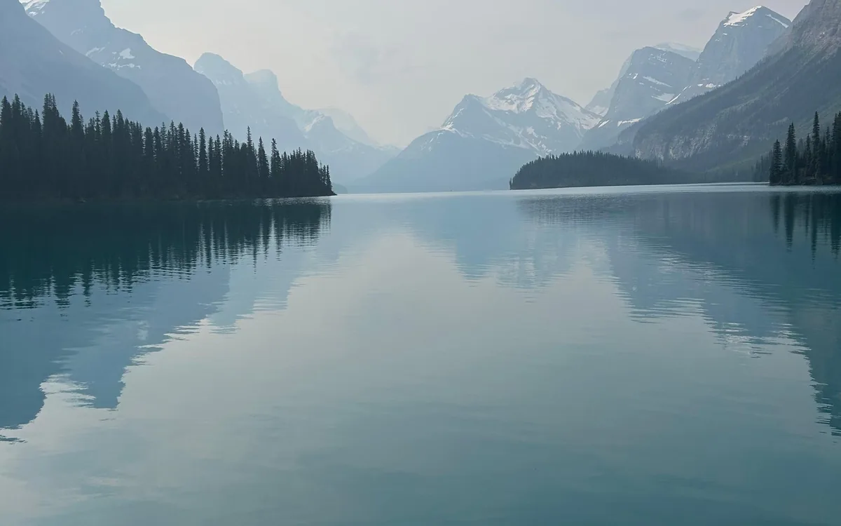 Still water on Maligne Lake in the early morning