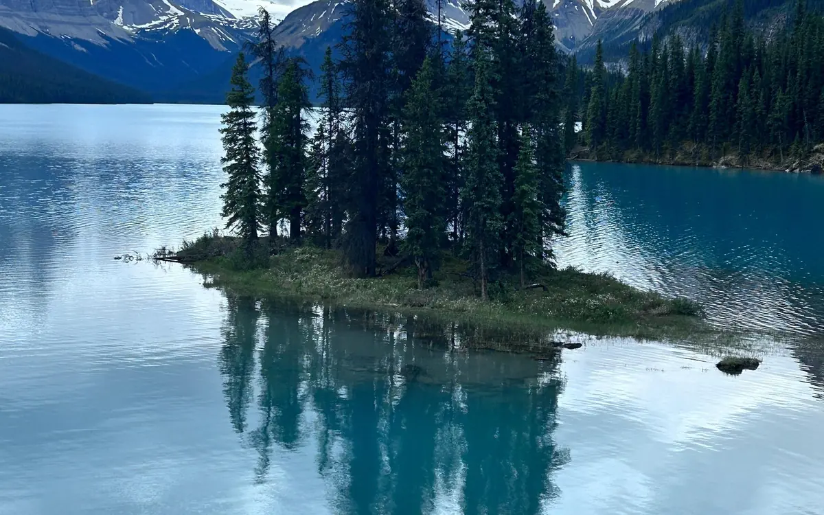Spirit Island reflected in the still water of Maligne Lake